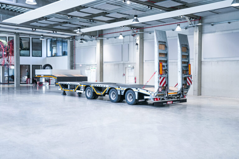 A semi-trailer from MAX Trailer with wheel recesses and ramps