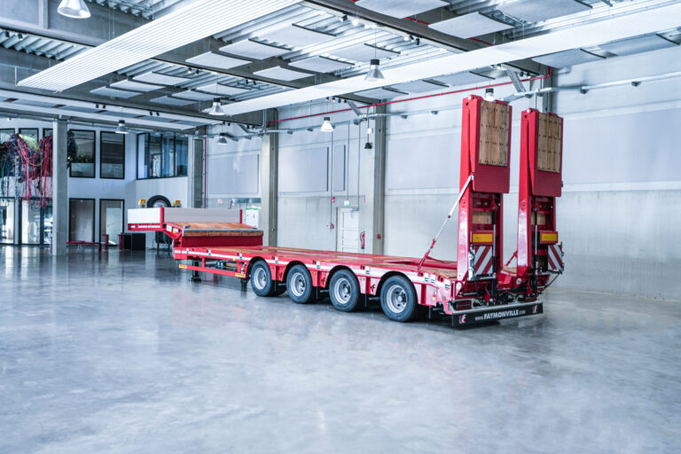 A 4-axle semi low loader from Faymonville with excavator trough and double ramps